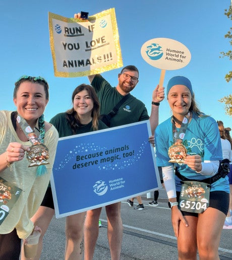 runDisney 2026 Walt Disney World Marathon Weekend runners with medals and signs