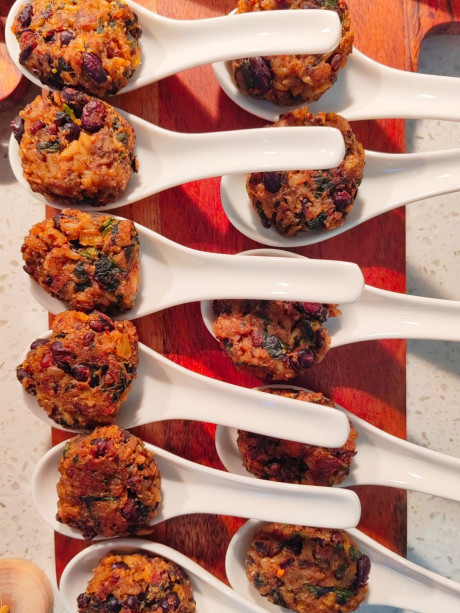Spoonfuls of African cowpea fritters with sorghum flour