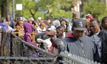 Line of people and their pets at Pets for Life event