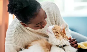 Woman cuddling with her cat