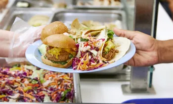 Plant-based food on a plate in a cafeteria. 