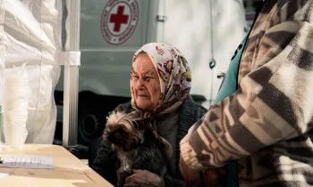 A woman receives aid for her dog
