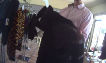 A person holds a fur coat