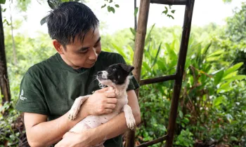 A man holding a dog