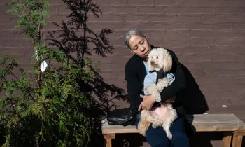 Woman holding a dog outside