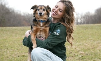 Staff holding puppy