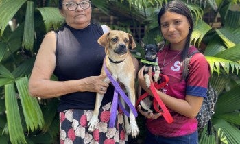 women holding a dog