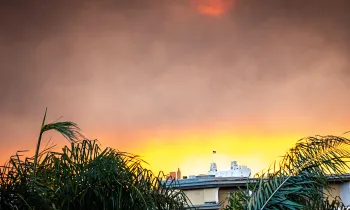 Smoke from the wildfire lights up the morning sunrise over downtown Los Angeles, CA.