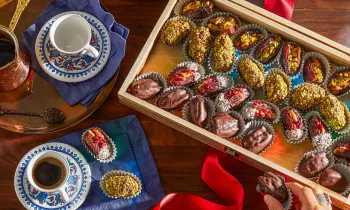 Photo from above of vegan stuffed dates displayed in a wooden box.