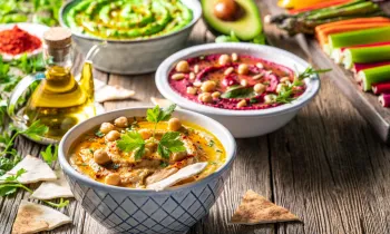 Various vegan dishes set on a table with other vegetables
