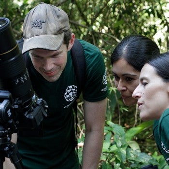 Humane Journeys: Costa Rica Three people looking at photos on a camera screen
