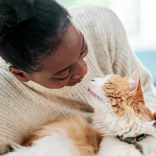 Woman cuddling with her cat