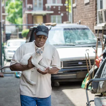 Man caring for a neighborhood cat in Detroit