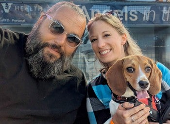 Nora the beagle with her adopted owners.