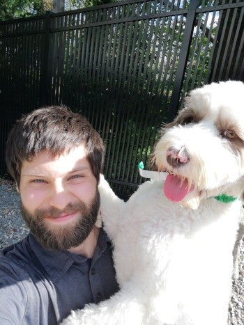 A man sitting with a dog