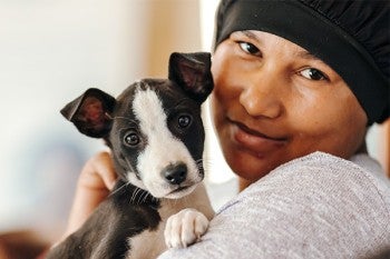 A community member holding their dog at a sterithon event