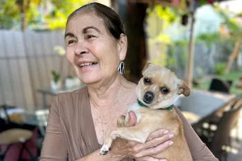 Lersie Feliciano holding a Chihuahua