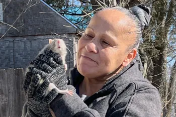 Maria Teresa Montoya holding a pet rat