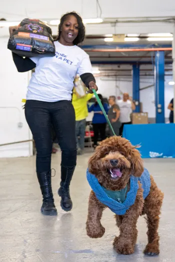 Woman at "Unpacking Pawty" event with her dog