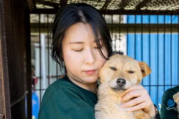 A woman holding a dog