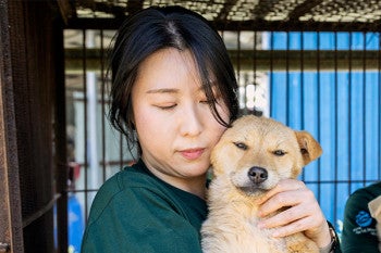 A woman holding a dog