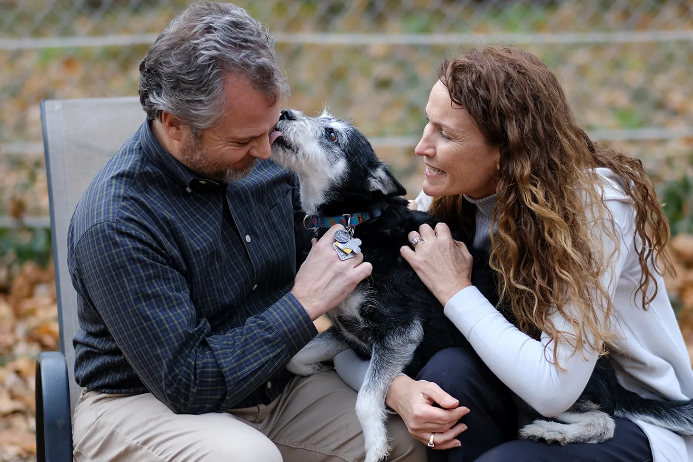 Susan and Doug with their dog Emma in the backyard at their home.