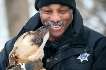 Dog kissing law enforcement 