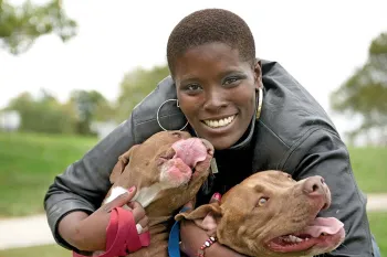 Megan Carman hugging her dogs