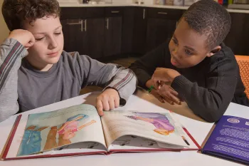 Boys reading puppy mill education materials