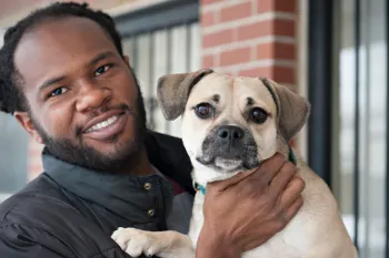 Pets for Life client holding his dog