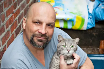 Man holding his grey cat