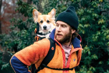 Bryan Reisberg with his corgi, Maxine, strapped into his self-designed backpack.