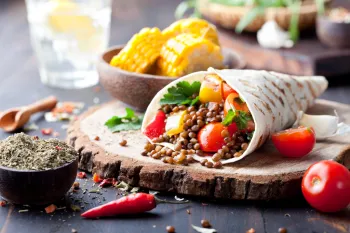 A wrap filled with lentils and vegetables.