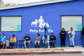 People waiting in line outside for Pets For Life services.