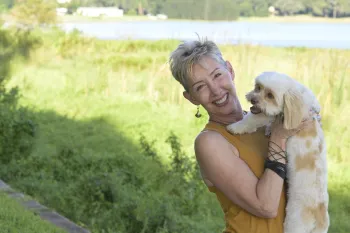 Debra Radford and Buddy pose for a portrait