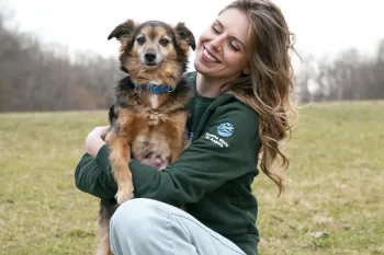 Staff holding puppy