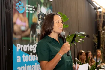 A woman in Chile talking into a microphone at an event