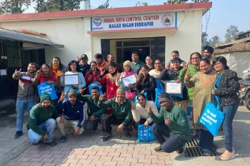 a group of people posing for a photo outside of a building
