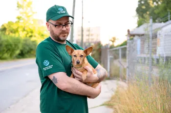 Staff member holding a dog