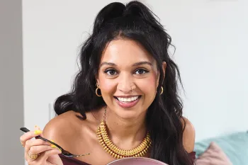 Chef Priyanka Naik, who is an Indian American vegan chef, as well as a Food Network champion, TV host, and author of The Modern Tiffin, in the kitchen cooking Bucatini a la Pumpkin with Pink Peppercorn and Pistachio