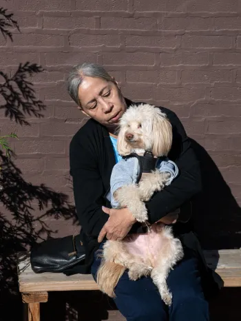 Woman holding a dog outside