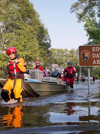 Animal rescue team carries rescued animals in a boat through flooded waters following Hurricane Harvey response