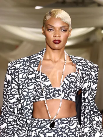 a fashion runway where a model is wearing a black and white ensemble