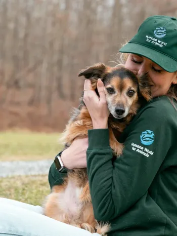 Humane World for Animals staff hugging a dog