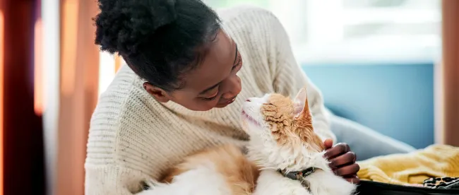 Woman cuddling with her cat
