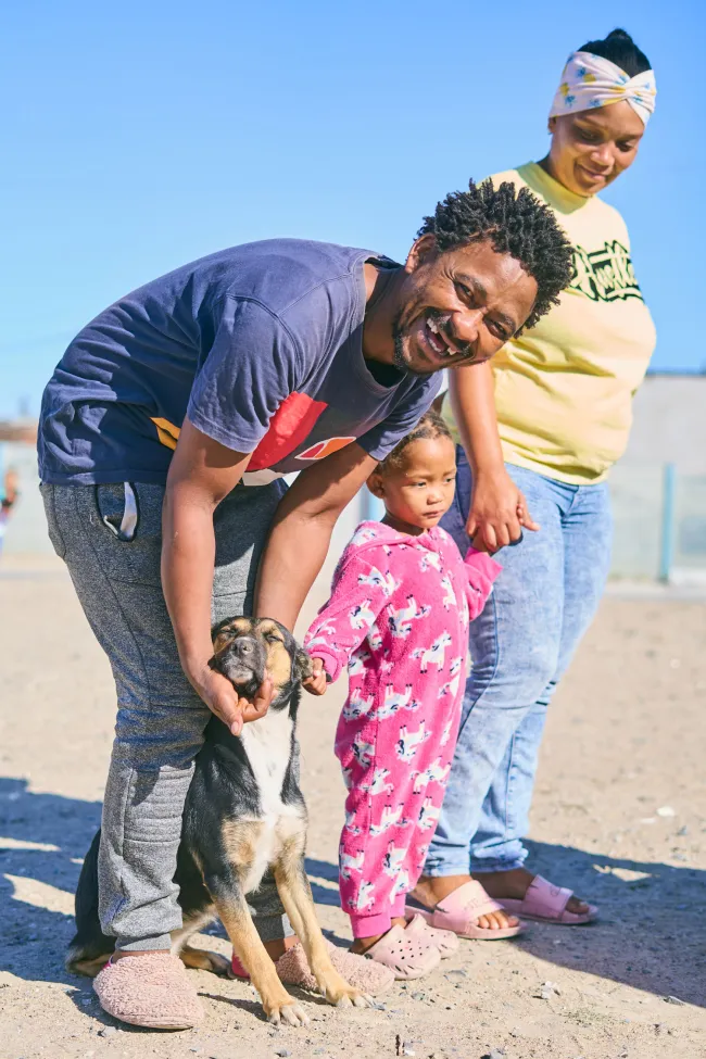 A person and a child petting a dog - South Africa Healthy Pets Healthy Community Clinic 2025