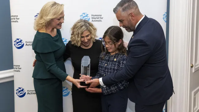 a group of people holding an award