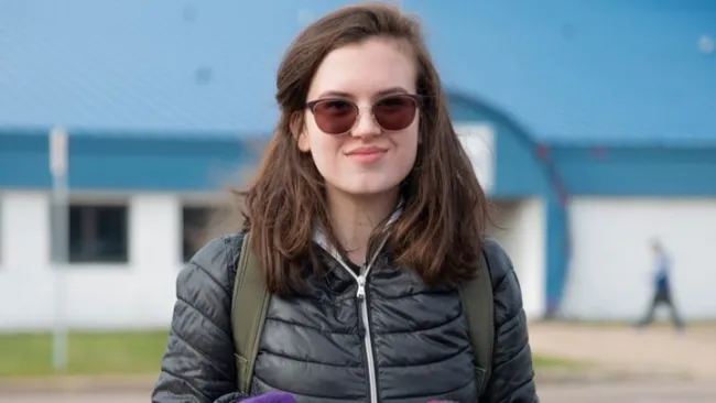 A woman wearing a black puffer jacket.