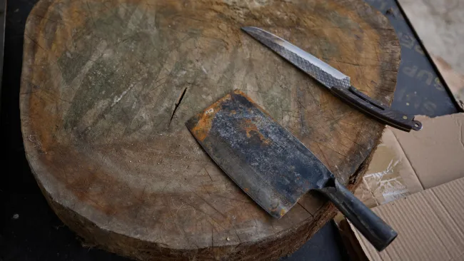 A knife and cleaver on a cutting board