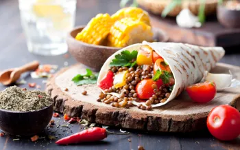 A wrap filled with lentils and vegetables.